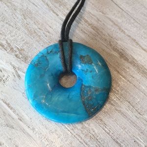 Turquoise disc on leather cord necklace. Styled in Spell Cha Cha campaign
